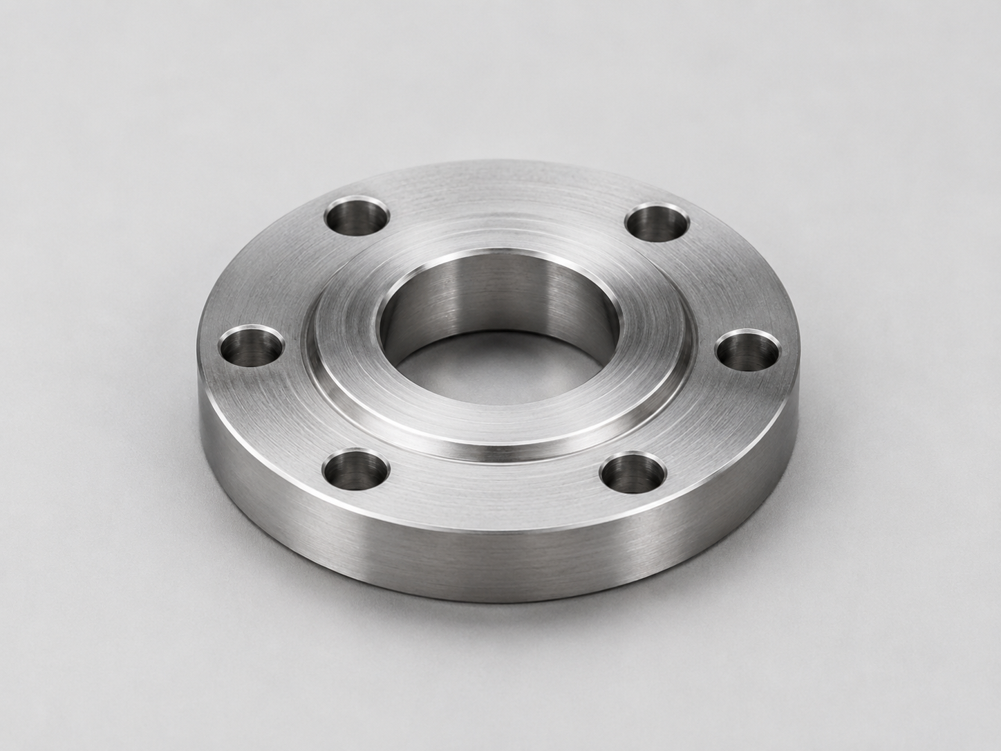 CNC machined flanged component with central bore and bolt pattern