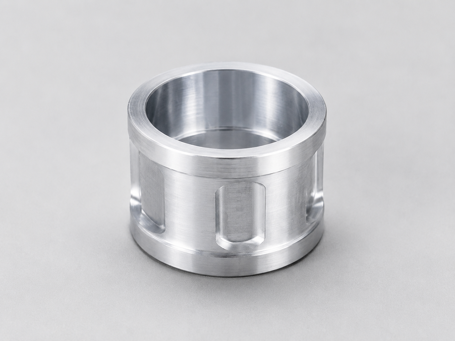 Machined sleeve and bushing component with bore and chamfer details
